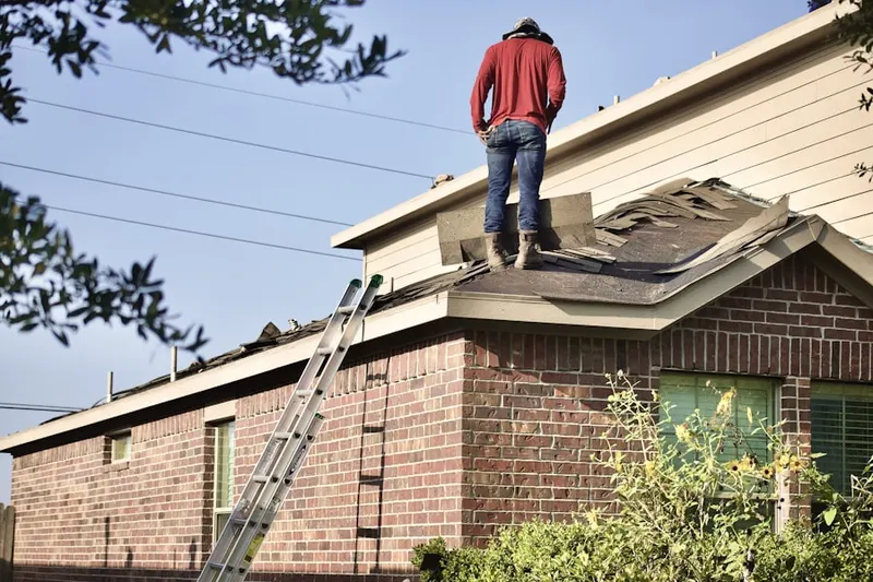 Professional roofer working on a residential roof in Dulaney Valley Estates